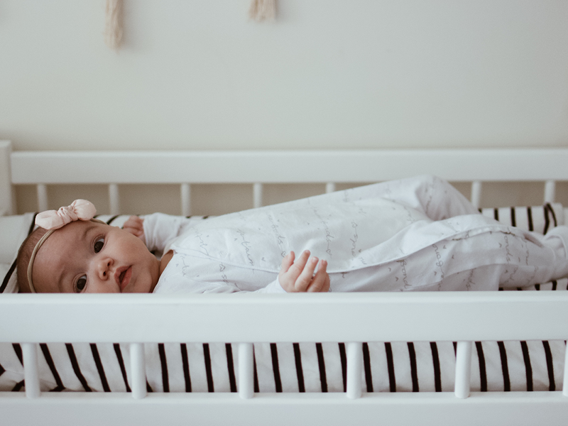 If swaddling your infant has become too tricky or they've aged out of the process, a baby sleep suit presents all of the same perks - but how do you choose one?