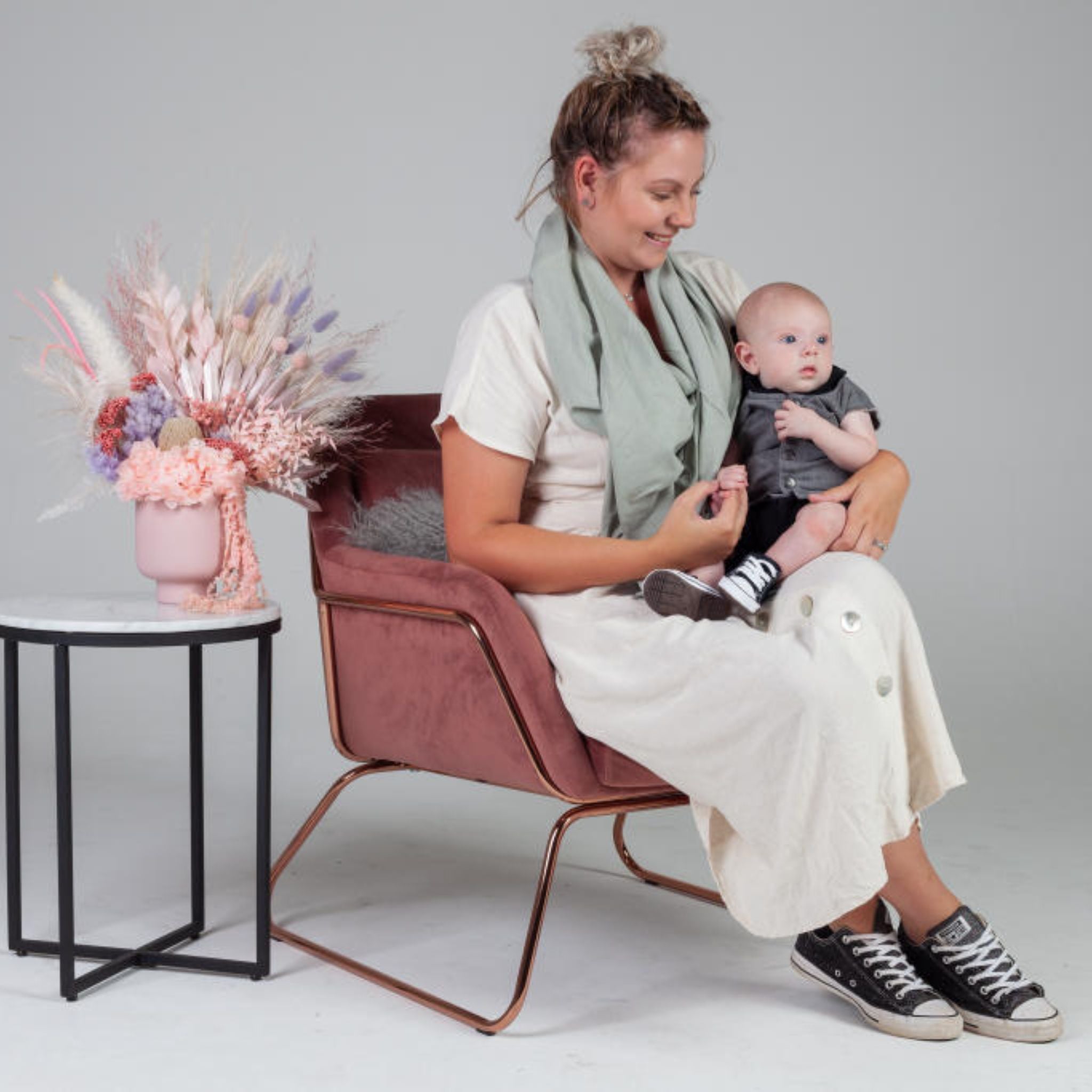 Women sitting on  the sofa with her baby